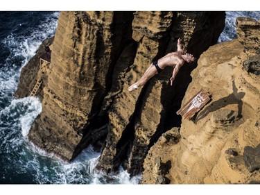VILA FRANCA DO CAMPO, PORTUGAL - JULY 26:  (EDITORIAL USE ONLY) In this handout image provided by Red Bull, Steven LoBue of the USA dives from 27 metres off the cliff face of Islet Vila Franca do Campo during the fifth stop of the Red Bull Cliff Diving World Series, Azores, Portugal.