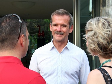Retired astronaut Chris Hadfield chats with Maj. Morgan Strachan from the Canadian Forces Snowbirds and his wife, Amanda Strachan, at the Hadfield Youth Summit Soirée hosted by Michael Potter on Monday, June 30, 2014, in Rockcliffe.