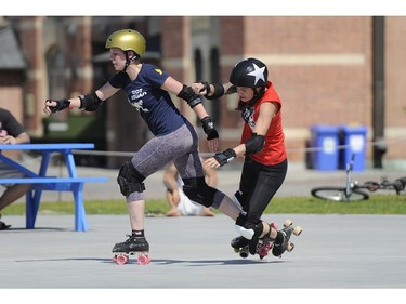 Riot Squad's Pix E. Cuts takes out Slaughter Daughters' jammer during the Rideau Valley Roller Girls' Roller Derby Expo at the Rink of Dreams at Ottawa City Hall's Marion Dewar Plaza in Ottawa on Saturday, July 12, 2014.