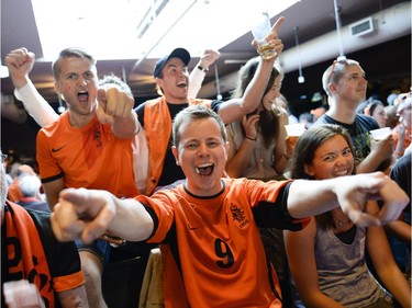 Robbie McCreight, centre, cheers for Netherlands during the FIFA World Cup 2014 match between Netherlands and Argentina at Hooley's on Wednesday, July 9, 2014.