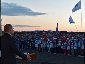 Russia's President Vladimir Putin (L) speaks during his visit to the construction site of new football stadium, one of the future venues of the 2018 World Cup, in the Volga River city of Samara 868 km (539 miles) southeast of Moscow, on July 21, 2014.