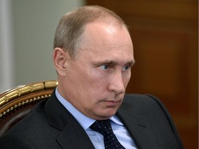 Russia's President Vladimir Putin attends a meeting in his Novo-Ogaryovo residence outside Moscow, on July 24, 2014.