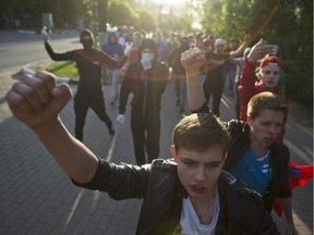 On May 15, Russian nationalists and soccer fans shout slogans during a rally to commemorate the death of a soccer fan Leonid Safyannikov, who was killed by an Uzbek on May 13 in Pushkino, about 20 kilometers from Moscow.  Some hundreds of people gathered near Pushkino railway station and marched through the town shouting slogans like "Russia for Russians".  Police detained about 40 activists.