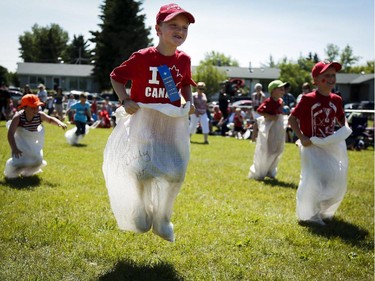 Seven-year-old Scott Sandilands competes in the sack race during Canada Day celebrations in Cremona, Alta., Tuesday, July 1, 2014