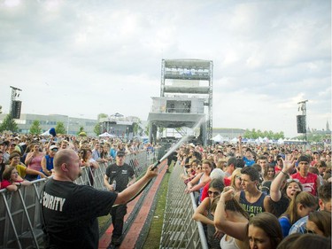 Security sprayed the crowd to cool them down before Tim Hicks hit the stage Sunday July 6, 2014 at Bluesfest held at LeBreton Flats.