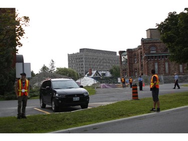 Security was tight around the 1,000 metre perimeter of the Sir John Carling Building (middle), which was demolished successfully, in Ottawa on Sunday morning, July 13, 2014.