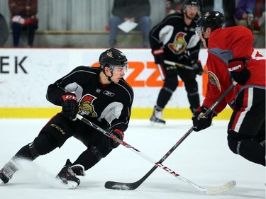 Shane Prince goes head to head with Curtis Lazar, right, at the Senators development camp, which had their final 3 on 3 tournament Monday July 7, 2014 at the Bell Sensplex.