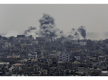 Smoke from Israeli strikes rises over Gaza City in the northern Gaza Strip on Sunday, July 27, 2014.