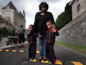 Sonia Elliott's two sons Knox, 2, left, and Moses, 5, were struck by a cyclist on the path beside the Ottawa Locks last Tuesday. Speed bumps have been installed to slow cyclists.