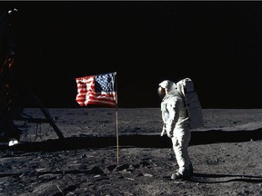 This July 20, 1969 file photo shows US Astronaut Edwin E. Aldrin, Jr., lunar module pilot of the first lunar landing mission, as he poses for a photograph beside the deployed United States flag during Apollo 11 Extravehicular Activity (EVA) on the lunar surface area called the Sea of Tranquility.