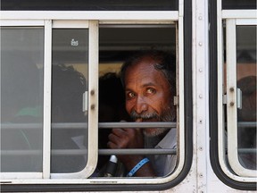 Sri Lankan asylum seekers sent back by Australia prepare to enter the magistrate's court in the southern port district of Galle on July 8, 2014. Sri Lankan authorities plan to charge a group of asylum-seekers with attempting to leave the country illegally after they were returned by Australia following a controversial mid-sea transfer.