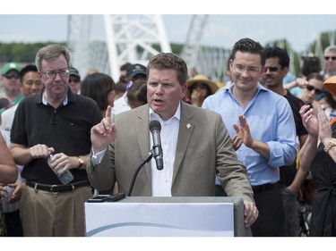 Steve Desroches, councillor for Gloucester - South Nepean, speaks during the grand opening of the Strandherd-Armstrong Bridge in Ottawa on Saturday, July 12, 2014. The bridge connects the communities of Barrhaven and Riverside South over the Rideau River.