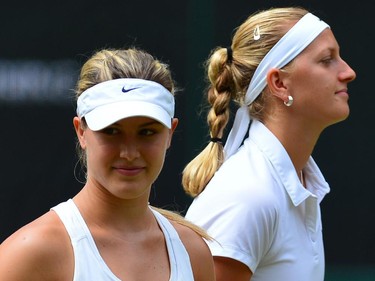 Canada's Eugenie Bouchard (L) and Czech Republic's Petra Kvitova (R) stand by the net after the coin toss before the start of their women's singles final match on day twelve of  the 2014 Wimbledon Championships at The All England Tennis Club in Wimbledon, southwest London, on July 5, 2014.