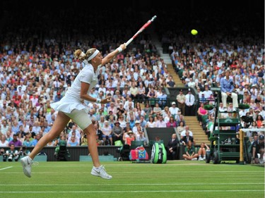 Czech Republic's Petra Kvitova returns to Canada's Eugenie Bouchard during their women's singles final match on day twelve of  the 2014 Wimbledon Championships at The All England Tennis Club in Wimbledon, southwest London, on July 5, 2014.