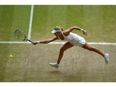 Canada's Eugenie Bouchard misses the ball as she reaches out for a return to Czech Republic's Petra Kvitova during their women's singles final match on day twelve of the 2014 Wimbledon Championships at The All England Tennis Club in Wimbledon, southwest London, on July 5, 2014.
