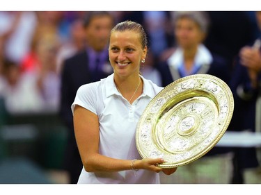Czech Republic's Petra Kvitova holds the winner's trophy during the presentation after beating Canada's Eugenie Bouchard in the women's singles final match on day twelve of  the 2014 Wimbledon Championships at The All England Tennis Club in Wimbledon, southwest London, on July 5, 2014.