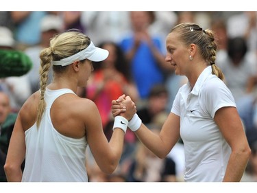 Czech Republic's Petra Kvitova (R) shakes hands with Canada's Eugenie Bouchard after Kvitova won their women's singles final match on day twelve of  the 2014 Wimbledon Championships at The All England Tennis Club in Wimbledon, southwest London, on July 5, 2014. Kvitova stormed to her second Wimbledon title in the shortest women's final at the All England Club since 1983 as the Czech sixth seed crushed Canada's Eugenie Bouchard 6-3, 6-0.