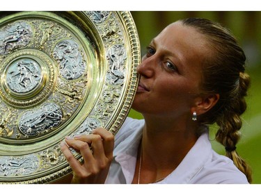 Czech Republic's Petra Kvitova kisses  the winner's Venus Rosewater Dish during the presentation after beating Canada's Eugenie Bouchard in the women's singles final match on day twelve of  the 2014 Wimbledon Championships at The All England Tennis Club in Wimbledon, southwest London, on July 5, 2014. Kvitova stormed to her second Wimbledon title in the shortest women's final at the All England Club since 1983 as the Czech sixth seed crushed Canada's Eugenie Bouchard 6-3, 6-0.