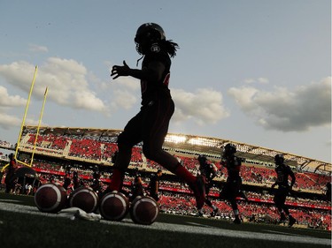 The Ottawa Redblacks warm up before home opener at TD Place on Friday, July 18, 2014.