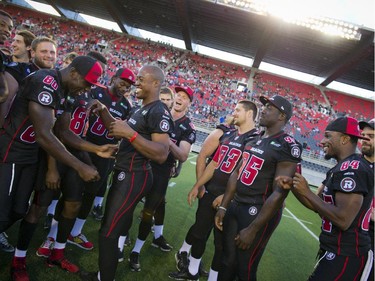 The Redblack players get pumped up at the official opening of TD Place at Lansdowne Wednesday July 9. 2014.