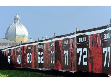 The retired jerseys of legendary Ottawa football players - which will be unveiled at the Redblack's home opener tonight - has its cover blow off. On the inaugural opening day of TD Place July 18, 2014.