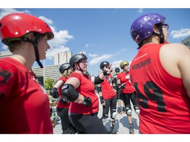 The Slaughter Daughters look on at their rivals during the Rideau Valley Roller Girls Roller Derby Expo at the Rink of Dreams at Ottawa City Hall's Marion Dewar Plaza in Ottawa on Saturday, July 12, 2014.