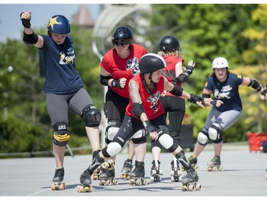 The Slaughter Daughters try to force out Riot Squad jammer Restless Rose during the Rideau Valley Roller Girls' Roller Derby Expo at the Rink of Dreams at Ottawa City Hall's Marion Dewar Plaza in Ottawa on Saturday, July 12, 2014.