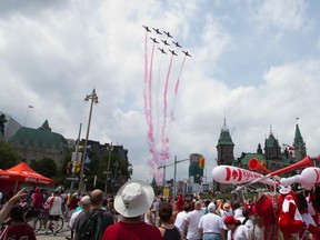 The snowbirds fly overhead as people flock to Parliament Hill and the downtown core to enjoy Canada's 147th birthday. Photo taken at 12:15 on July 1, 2014.