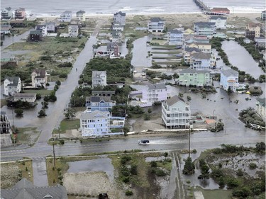 This Friday, July 4, 2014 aerial photo provided by the U.S. Coast Guard shows flooding caused by Hurricane Arthur on the Outer Banks of North Carolina. Arthur struck North Carolina as a Category 2 storm with winds of 100 mph late Thursday, taking about five hours to move across the far eastern part of the state.