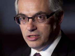 Treasury Board President Tony Clement speaks with the media about negotiations with the public service, Wednesday March 26, 2014 in Ottawa. The federal government continues to collect background information on individuals who file access-to-information requests, more than seven months after officials agreed to stop the practice.