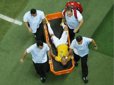 Brazil's forward Neymar is carried on a stretcher after being injured during the quarter-final football match between Brazil and Colombia at the Castelao Stadium in Fortaleza during the 2014 FIFA World Cup on July 4, 2014.