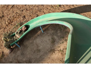 An Israeli soldier from the infantry unit sleeps on a slide at an Israeli village near the border with the Hamas-controlled Gaza Strip, on July 27, 2014, after returning from combat inside Gaza. The Islamist Hamas movement belatedly accepted diplomatic calls for an extension of a humanitarian ceasefire in Gaza shortly after Israel said it was resuming its devastating military assault.