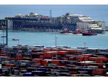 The refloated wreck of the Costa Concordia cruise liner is towed to the Italian port of Genoa on July 27, 2014. The wreck of the Costa Concordia entered the Italian port of Genoa on July 27, ending the cruise liner's final journey to be scrapped two and a half years after it capsized at a cost of 32 lives. The once-luxury liner was dragged into Genoa's Voltri port by several tug boats, four days after leaving its wreck site off the Tuscan island of Giglio in an unprecedented salvage operation