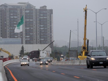 Traffic on the eastbound Queensway / 417 moves slowly through the downtown core after a tractor trailer (background) jack-knifed just east of Nicholas St. in Ottawa, Thursday, July 31, 2014.