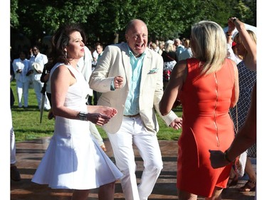 United States Ambassador Bruce Heyman (M)) and Mrs. Vicki Heyman (L) dance as they host the annual Fourth of July Independence Day celebration at their residence in Ottawa, July 04, 2014.