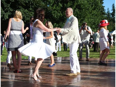 United States Ambassador Bruce Heyman (R) and Mrs. Vicki Heyman (L) dance as they host the annual Fourth of July Independence Day celebration at their residence in Ottawa, July 04, 2014.