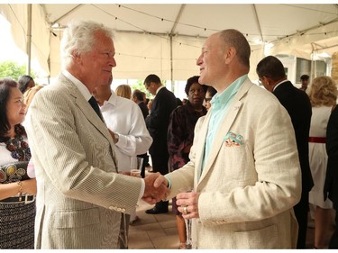 United States Ambassador Bruce Heyman (R) greets Ken Taylor, former Canadian Ambassador in Iran, during the annual Fourth of July Independence Day celebration at US Ambassador's residence in Ottawa, July 04, 2014.