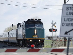 VIA rail train at a crossing on Fallowfield Road on Saturday, May 10, 2014.