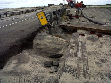 Water from Hurricane Arthur buckled a section of North Carolina Highway 12 on Hatteras Island, seen in a Friday, July 4, 2014 photo provided by the North Carolina Department of Transportation. It is the same spot on Hatteras Island that was breached in Hurricane Irene in 2011. Proving far less damaging than feared, Hurricane Arthur left tens of thousands of people without power Friday in a swipe at North Carolina's dangerously exposed Outer Banks, but the weather along the narrow barrier islands had already cleared by Friday afternoon.