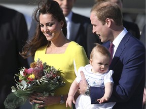 Britain's Prince William holding his son Prince George and his wife Kate, Duchess of Cambridge, arrive in Sydney Wednesday, April 16, 2014. The royal couple are on a three-week tour of Australia and New Zealand, the first official trip overseas with their son, Prince George.