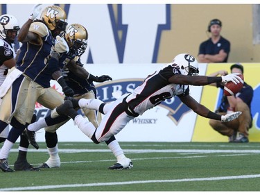 Winnipeg Blue Bombers could only watch as Ottawa Redblacks Dobson Collins dives in for a first quarter touchdown during CFL action at Investors Group Field in Winnipeg Thursday night.