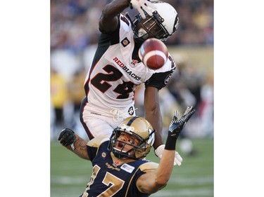Winnipeg Blue Bombers Nick Moore gets stripped of the ball during a second quarter pass attempt by Ottawa Redblacks Jerrell Gavins during CFL action at Investors Group Field in Winnipeg Thursday night.