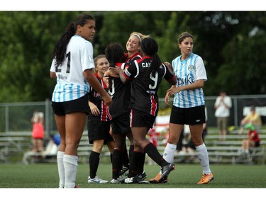 Women's Ottawa Fury FC celebrate a goal against Kitchener-Waterloo United FC during play action at Algonquin College Field on Saturday, July 19, 2014.