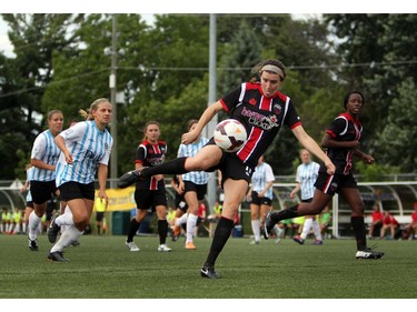 Women's Ottawa Fury FC's Annie Steinlage eyes a ball as kicks it upfield against Kitchener-Waterloo United FC during play action at Algonquin College Field on Saturday, July 19, 2014.