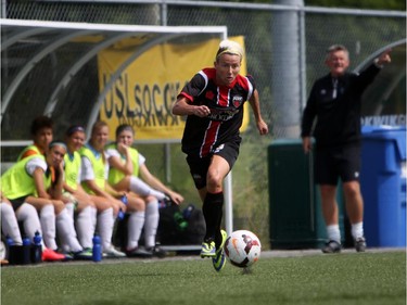 Women's Ottawa Fury FC's Kristy Moore eyes a ball as rushes upfield against Kitchener-Waterloo United FC during play action at Algonquin College Field on Saturday, July 19, 2014. (Cole Burston/Ottawa Citizen)