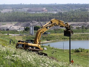 Workers are building a new well to collect gases from trash buried beneath 'Carp Mountain' at the Carp Road landfill. Canadian Tire Centre and the Ottawa skyline are visible in the background.