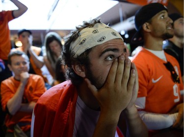 Zac Delamont, centre, cheering for Netherlands reacts during the FIFA World Cup 2014 match between Netherlands and Argentina at Hooley's on Wednesday, July 9, 2014.