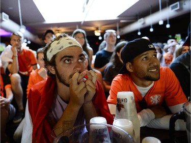 Zac Delamont, centre, cheering for Netherlands reacts during the FIFA World Cup 2014 match between Netherlands and Argentina at Hooley's on Wednesday, July 9, 2014.