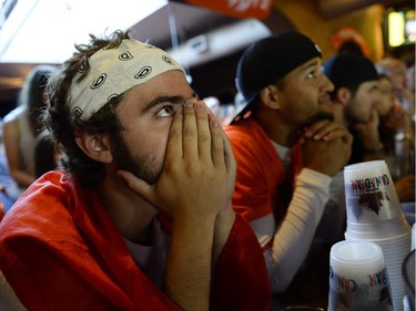 Zac Delamont (left), cheering for Netherlands reacts during the FIFA World Cup 2014 match between Netherlands and Argentina at Hooley's on Wednesday, July 9, 2014. (James Park / Ottawa Citizen)