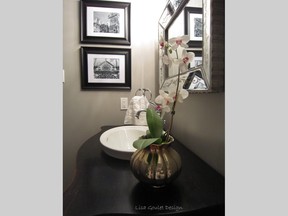 Interior designer Lisa Goulet turns her vacation photos into works of art, like these black and white prints of Paris in her powder room.